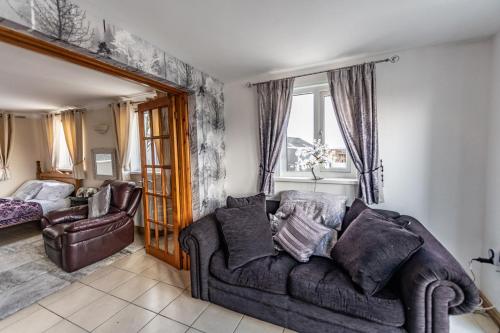 a living room with a couch and a chair at Pantysgyfarnog near Carmarthenshire Pembrokeshire in Carmarthen