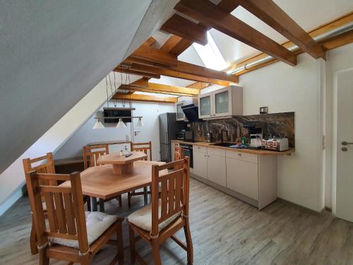 a kitchen and dining room with a table and chairs at Numero1-Pension und Cafe in Rübeland