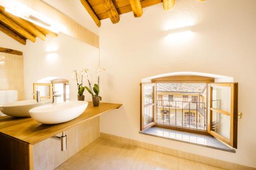 a bathroom with two sinks and a window at Alp Apartments - Xavier in Aosta