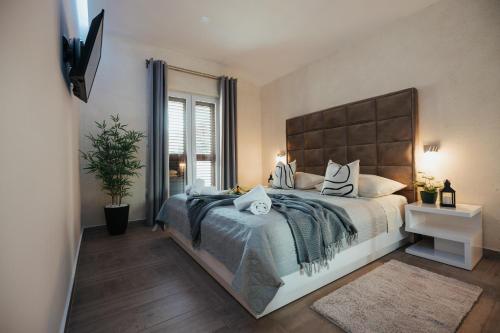 a bedroom with a large bed and a window at Apartments Niko in Makarska