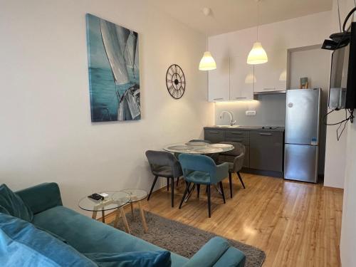 a living room with a couch and a table and a kitchen at Apartments Adriatic Blue in Dubrovnik