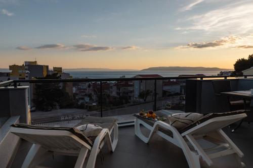 a balcony with two chairs and a table with a view at Apartments Niko in Makarska