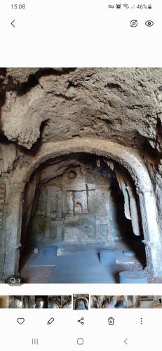 two pictures of a cave with a stone wall at Le Logis des Templiers appartement climatisé in Régusse