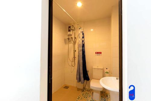 a bathroom with a shower and a toilet and a sink at Bed By City Hotel in Bangkok