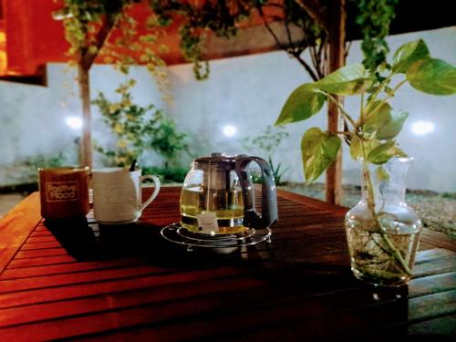 a tea kettle and a cup on a wooden table at Dimora d'Estate (Sicilian Holidays) in Milazzo