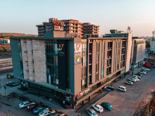 a large building with cars parked in a parking lot at Trivelles Executive Suites Islamabad in Islamabad