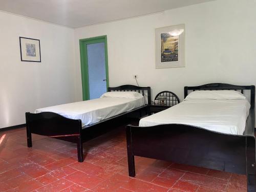 two beds sitting next to each other in a room at Villa Verde in Valsolda