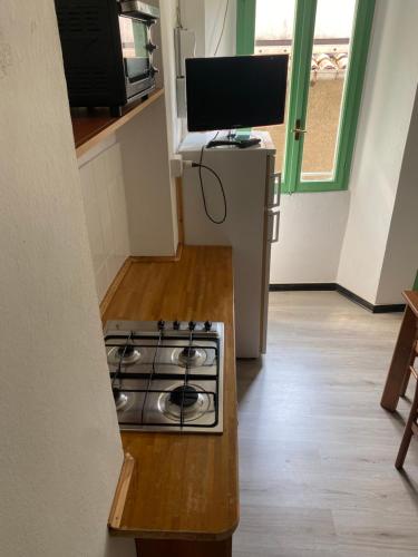 a kitchen with a stove top oven in a room at Villa Verde in Valsolda