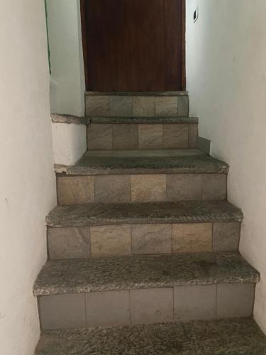 a set of stairs with a door on top at Villa Verde in Valsolda