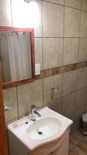 a bathroom with a sink and a mirror at Entre Viñedos in Ciudad Lujan de Cuyo