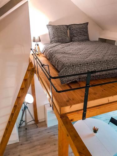 - une chambre avec un lit sur une plate-forme en bois dans l'établissement Le Chaudron d'Or - 41m2 - Hyper Centre - Mezzanine - Clim - WIFI HD, à Amiens