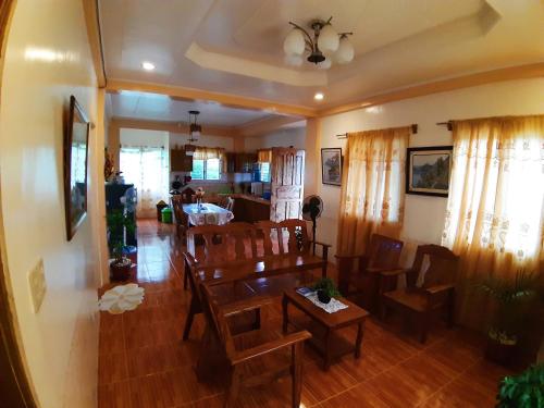 a dining room and living room with a table and chairs at Horlina’s Homestay in Basco