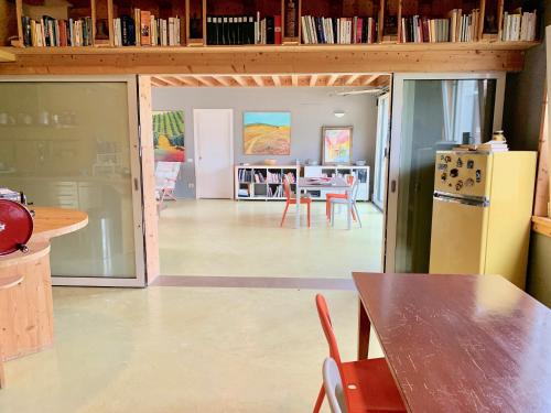a kitchen and dining room with a table and a refrigerator at Casale Artemisia Capalbio in Capalbio