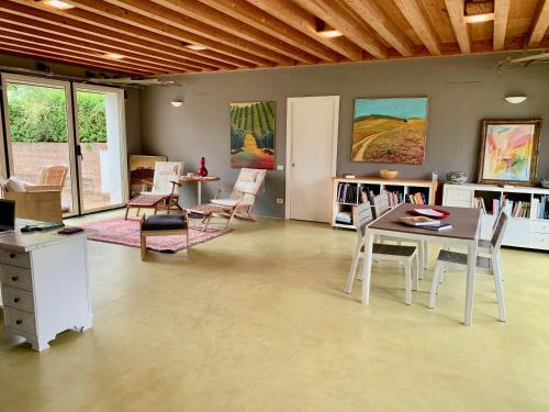 a living room with a table and chairs at Casale Artemisia Capalbio in Capalbio
