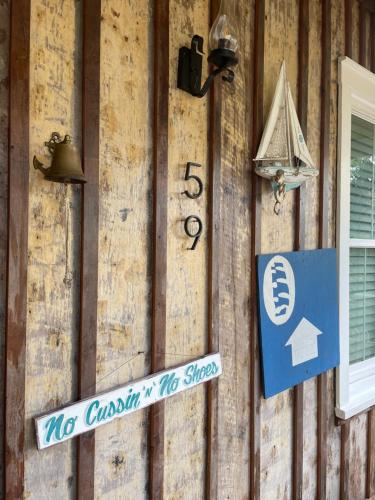 a sign on the side of a building with a street sign at 150-year-old Lincolnville cottage 3bedroom 2bath in St. Augustine