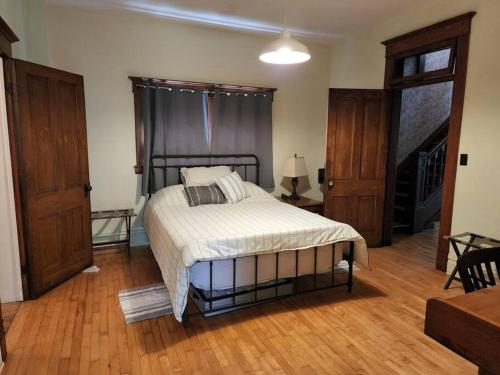 a bedroom with a bed in a room with wooden floors at BaseCampWV-Durbin. Spacious 4 bedroom house w/yard in Durbin