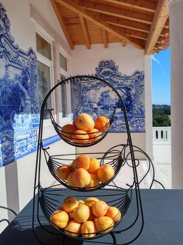 two baskets of oranges sitting on top of a table at Quinta da Marmela in Torres Novas