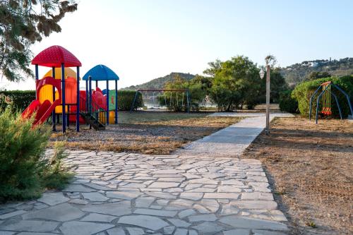 a park with a playground with a play equipment at Galaxy Hotel in Porto Heli