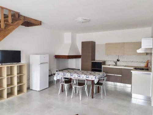 a kitchen with a table and some chairs in it at Sabrina in Rosolina Mare