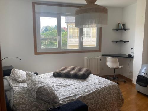 a bedroom with a bed with a pillow on it at apartamento costa da morte cabana de bergantiños in A Coruña