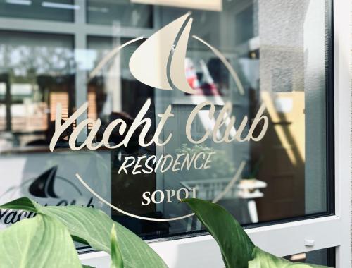 a sign on a window of a restaurant at Yacht Club Residence Sopot in Sopot
