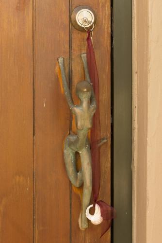 a door handle with a person holding an umbrella at Crab Cove in Mahinepua
