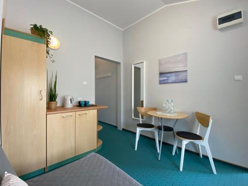 a room with a table and two chairs and a table at Yacht Club Residence Sopot in Sopot