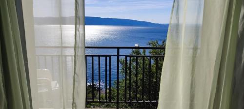 a view of the ocean from a window at Apartment and Rooms Busa 3 in Senj