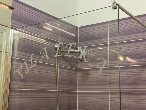 a shower with a faucet in a room at Hotel Fron in Sarandë