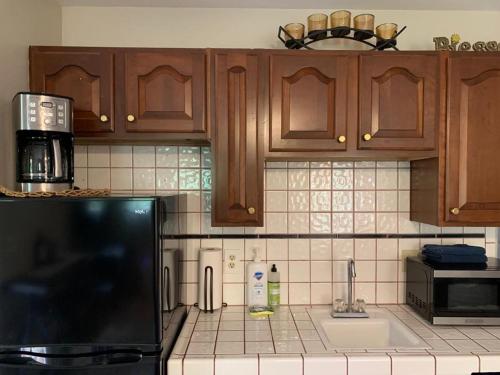 a kitchen with wooden cabinets and a counter top at YoBee! Park Reservation Included! Heart of Yosemite - Homey Studios and Breakfast in Yosemite West
