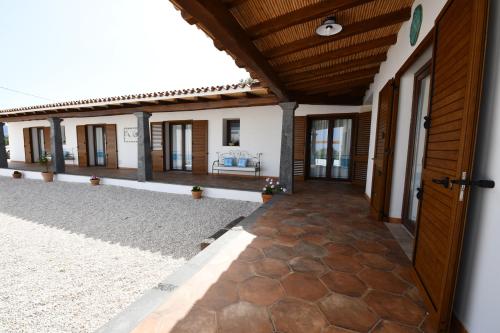 an external view of a house with a corridor at Tenute Efis in Galtellì