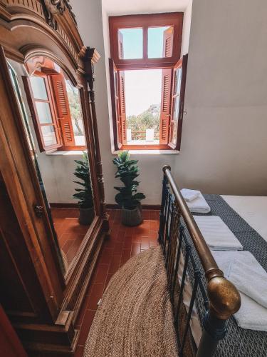 a bedroom with a bed and a large mirror at Villa Antigoni Serifos in Serifos Chora