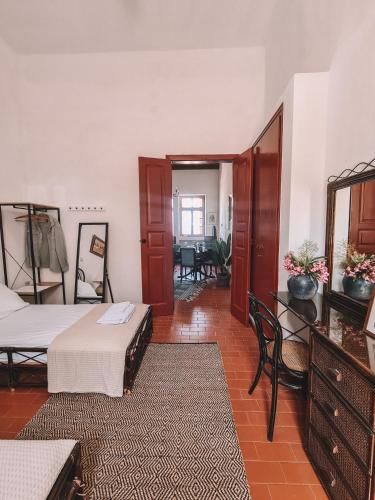 a bedroom with two beds and a dining room at Villa Antigoni Serifos in Serifos Chora