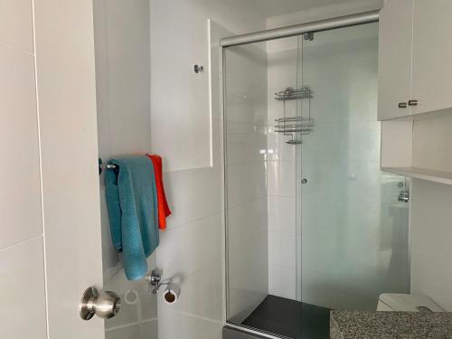 a shower with a glass door in a bathroom at Céntrico mini departamento, moderno y acogedor in Lima