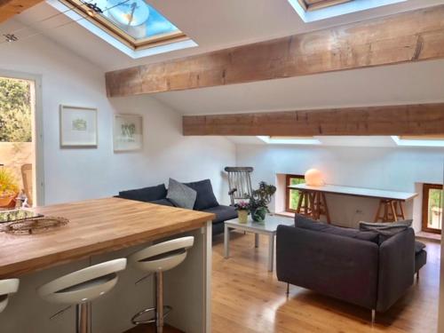 a kitchen and living room with a table and chairs at La Souqueto in Mirepeisset