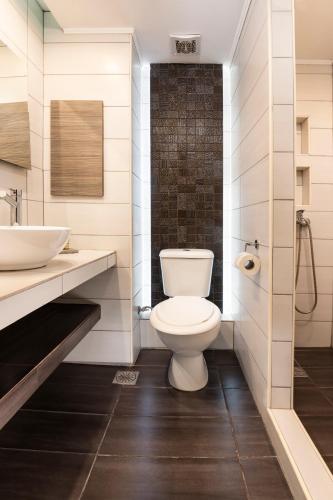 a bathroom with a toilet and a sink at Galaxy Hotel in Porto Heli