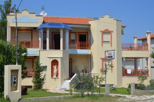 a large house with a blue roof at Villa Roxani in Limenas