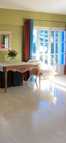 a living room with a table with a vase on it at Villa-Agave , by the sea in Porto-Rafti outside Athens in Porto Rafti