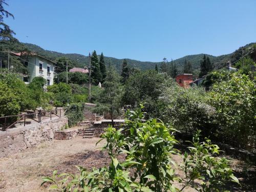 a view of a hill with a house and trees at B&B San Gregorio SINNAI in San Gregorio