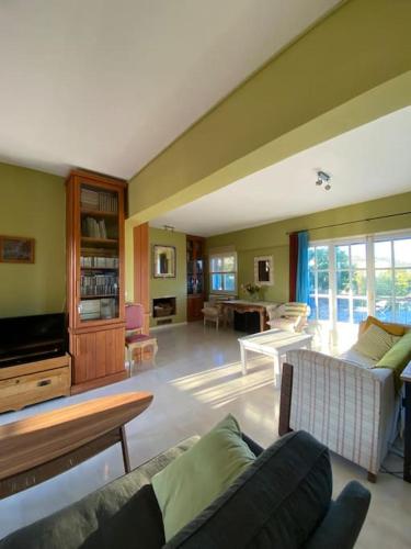 a living room with a couch and a table at Villa-Agave , by the sea in Porto-Rafti outside Athens in Porto Rafti
