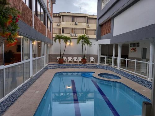 a swimming pool in the middle of a building at Hotel Napolitano in Villavicencio