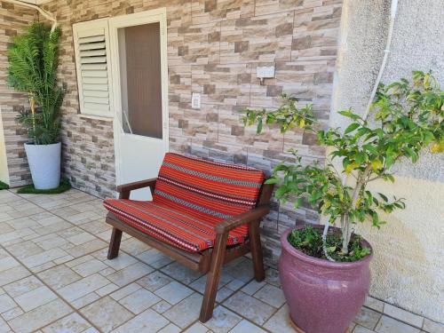 a wooden chair sitting on a patio next to a building at SAMA Tarshiha in Ma'alot Tarshiha