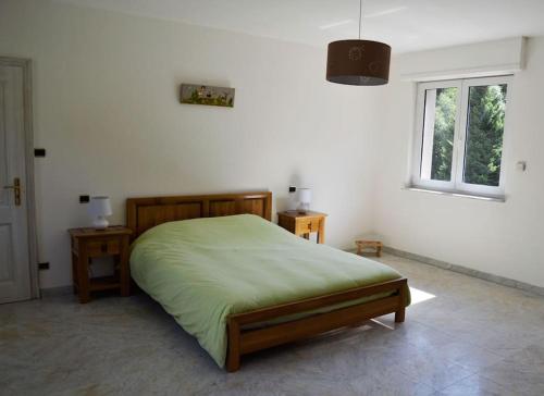 a bedroom with a bed and two tables and a window at Gite GRETEL de la Ferme du Schneeberg in Wangenbourg