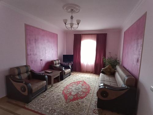 a living room with leather furniture and a window at Green Garden in Ijevan