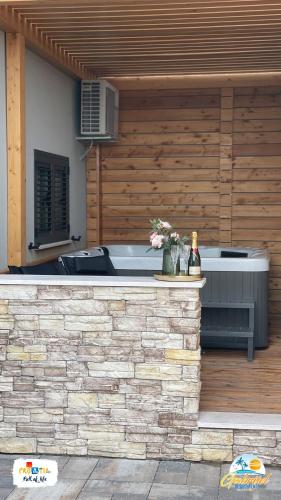 a outdoor bar with a hot tub and flowers at Gabrijel Apartments Makarska 1 in Makarska