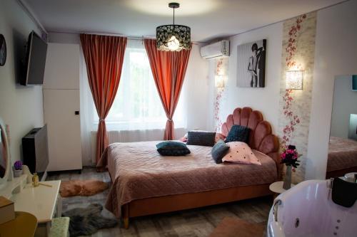a bedroom with a bed with a large window at Pink Boutique in Campina