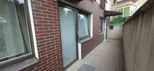 an empty alley with a brick building and a window at Elite Flats Two bedroom in Utena