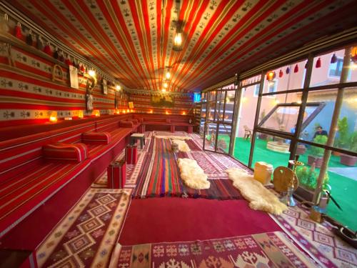 a large room with red carpeting and a ceiling at Petra Aretas Hotel in Wadi Musa