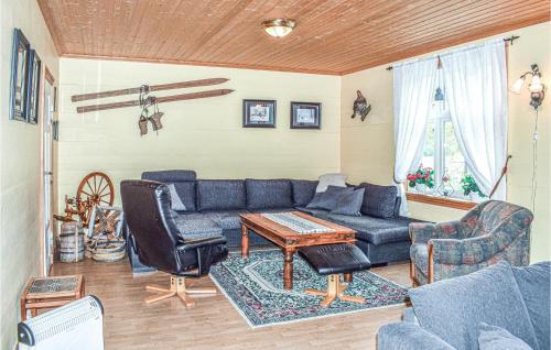 a living room with a blue couch and a table at Nice Home In Vik I Sogn With Jacuzzi in Åse
