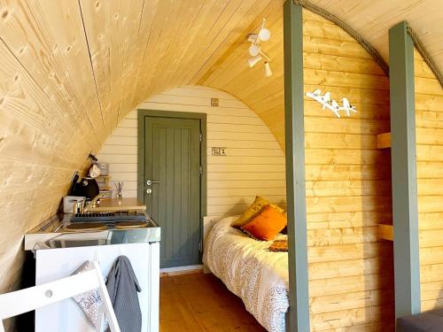 a small kitchen with a bed in a room at BrackenXcapes Glamping in Newark upon Trent